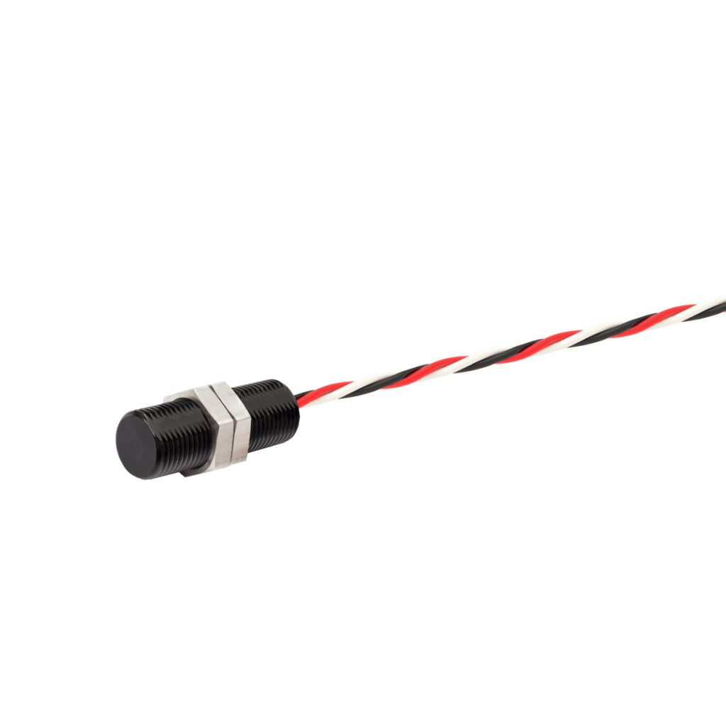 A cylindrical black Angle Position Sensor from the APS Series, featuring a threaded body and secured by a metal nut, is attached to a twisted red, white, and black cable. The device is set against a white background. by Standex Detect