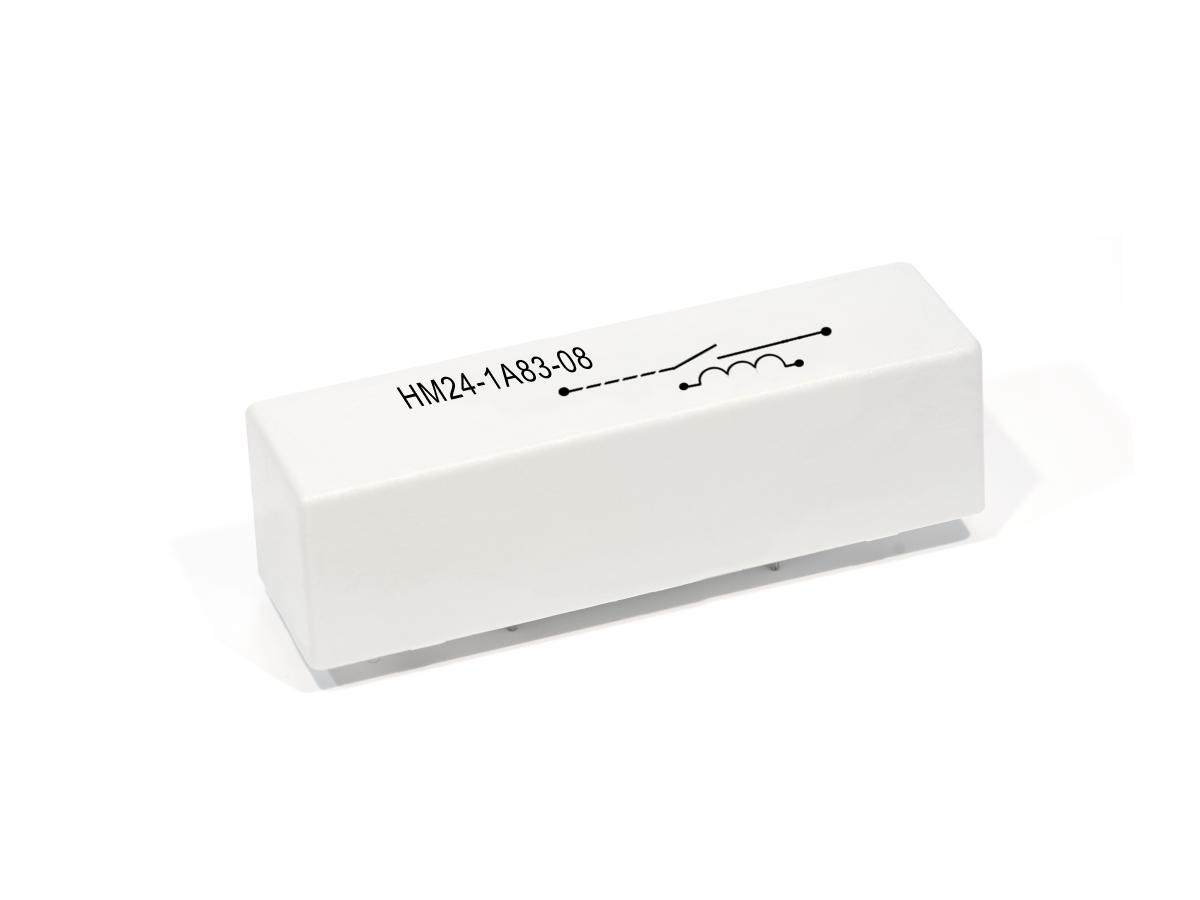 A rectangular white electronic component from the HM Series, labeled HM24-1A83-08, with a simple circuit diagram printed in black on its top surface, commonly used as a reed relay in various electronic applications. by Standex Detect