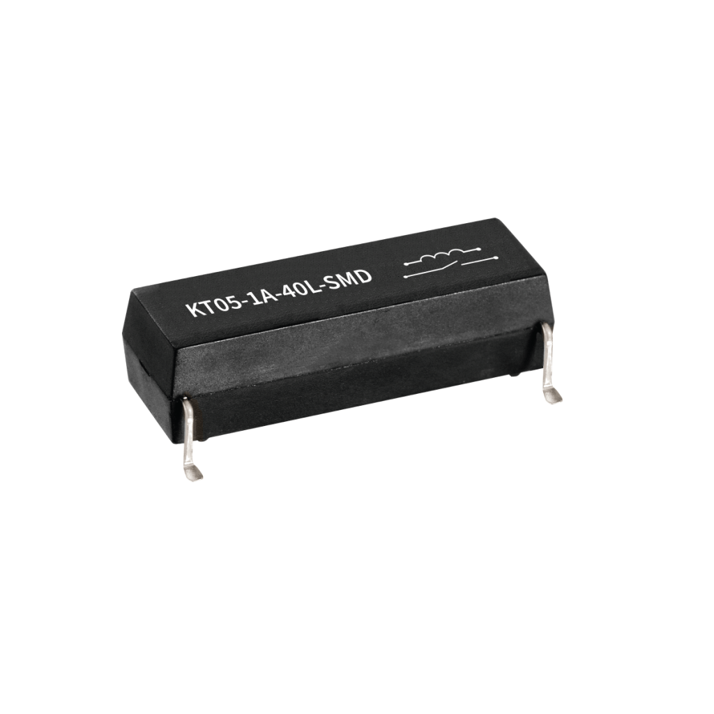 A black rectangular KT Series Reed Relay, labeled KT05-1A-40L-SMD, features four metal pins for surface mounting, photographed on a white background. by Standex Detect