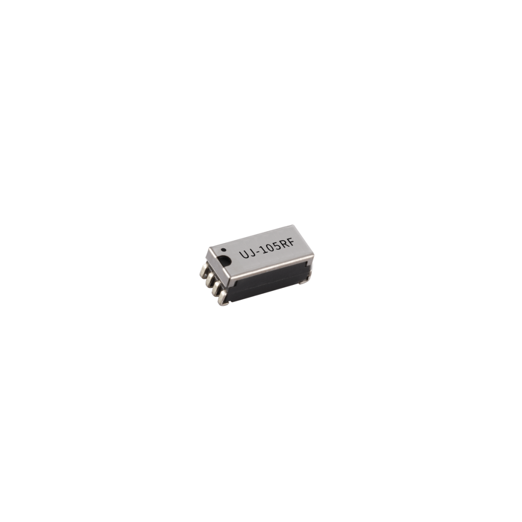 A small integrated circuit chip with the label UJ-10SRF printed on the top, featuring eight metal pins for connection and showcasing its unique characteristics, isolated on a white background. by Standex Detect