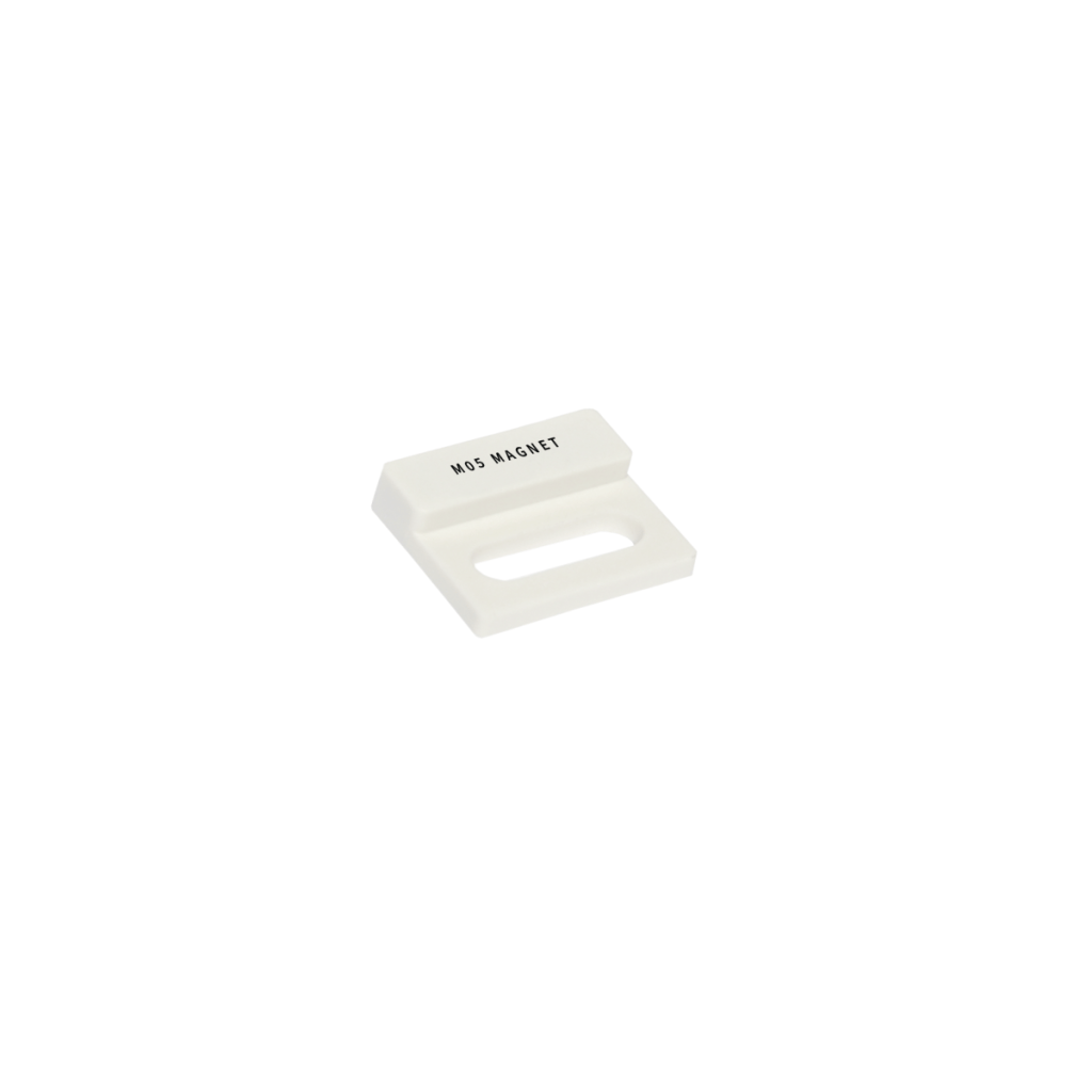 A small, white rectangular object labeled HDS MAGNET from the M02 Series Magnet line, featuring a slanted top and a cutout section, isolated on a white background. by Standex Detect