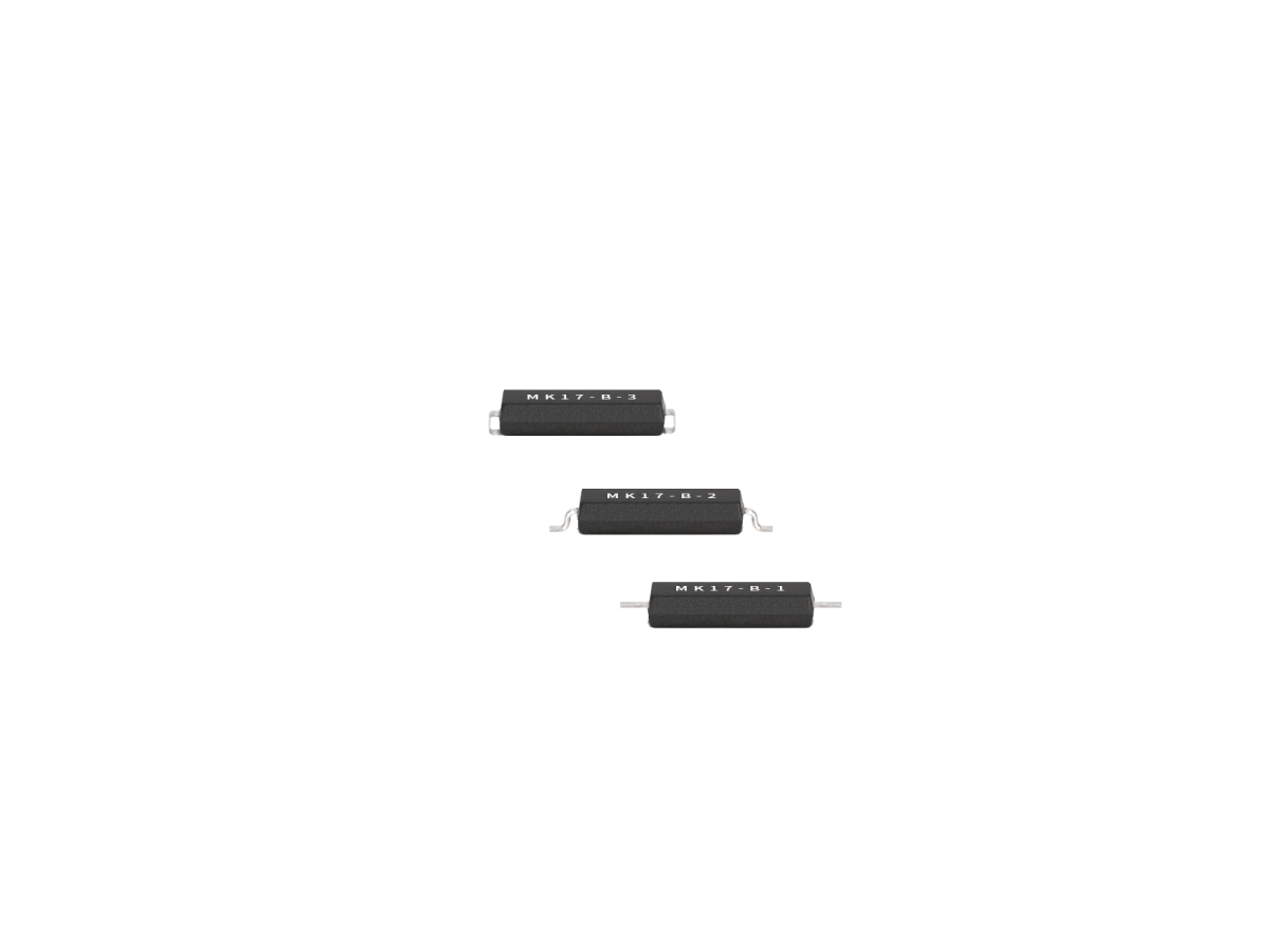 Three small black rectangular Surface Mount Reed Switch components from the MK17 Series, labeled “MR17-B-2,” are arranged in a diagonal line on a white background. Each component has metal leads on both sides. by Standex Detect
