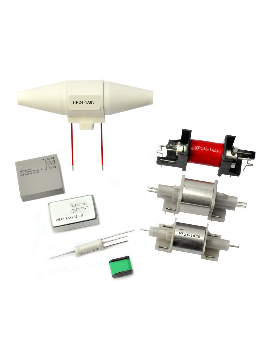 A variety of electronic components, including cylindrical fuses, custom relays, rectangular modules, and other circuit protection devices, are arranged on a white background. by Standex Detect