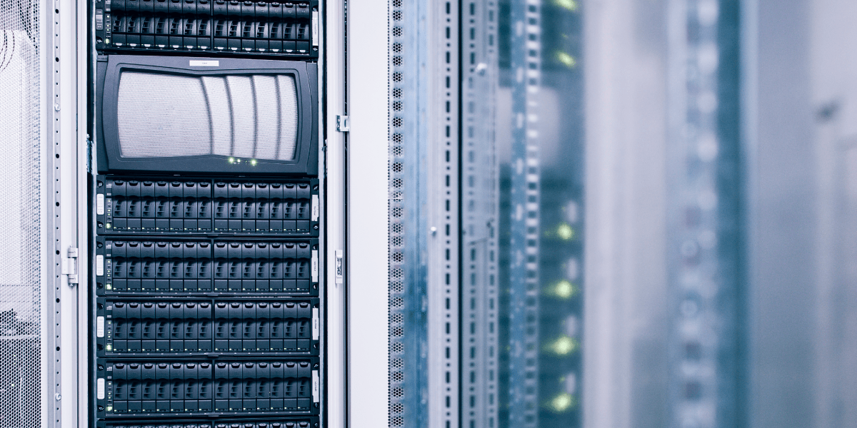 A close-up of server racks in a data center, showing rows of black hardware with indicator lights and a monitor screen on one rack. The image is cool-toned, with a modern, high-tech feel—ideal for High-Pulsed Current Testing environments. by Standex Detect