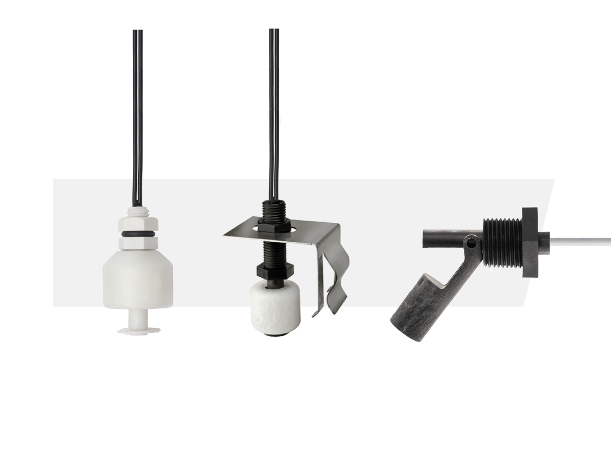 Three energy efficient sensor float switches are shown: one with a cylindrical float, one with a square metal bracket, and one with a right-angle black plastic design, all attached to cables. by Standex Detect