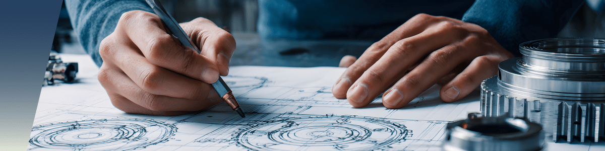 A person’s hands sketch detailed mechanical gears and parts, including liquid level sensors and floats, on technical blueprints at a worktable, surrounded by metal components and engineering tools. by Standex Detect