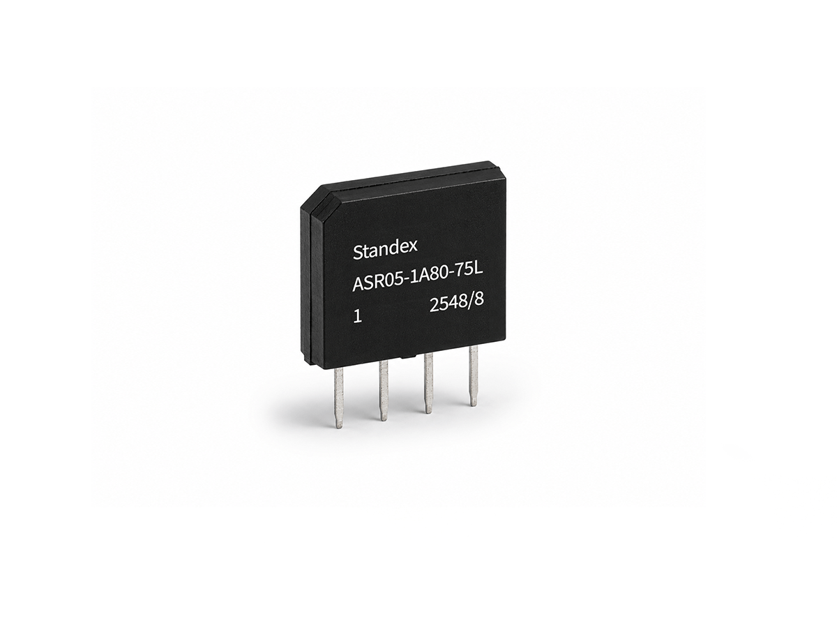 A black rectangular Reed Relay from the ASR Series with four metal pins, labeled Standex ASR05-1A80-75L 1 2548/8, standing upright on a white background. by Standex Detect
