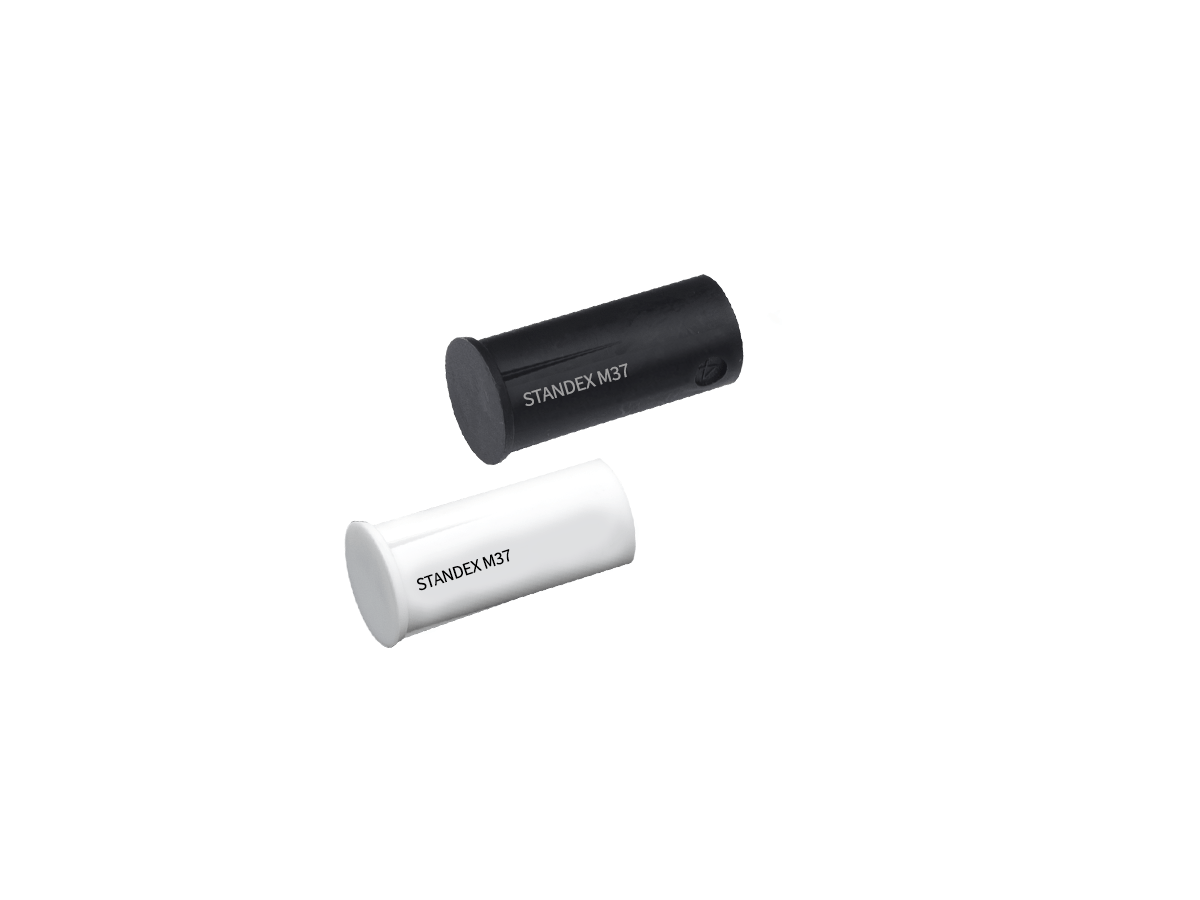 Two cylindrical objects, one black and one white, each labeled “STANDEX M3T,” from the M36 series magnet collection, are placed diagonally on a plain white background. by Standex Detect